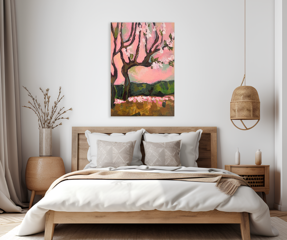 Cherry Blossom Dream canvas wall art displayed above a wooden bed in a neutral bedroom with soft pink floral landscape painting