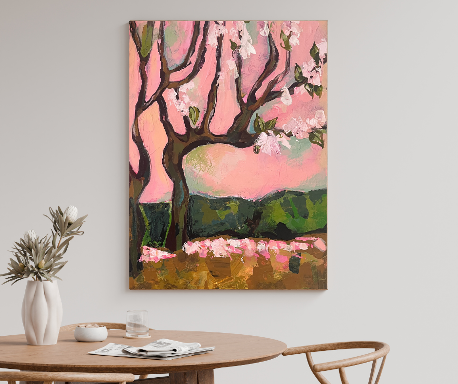 Cherry Blossom Dream canvas wall art above a wooden dining table in a minimal neutral dining room with soft pink floral landscape painting