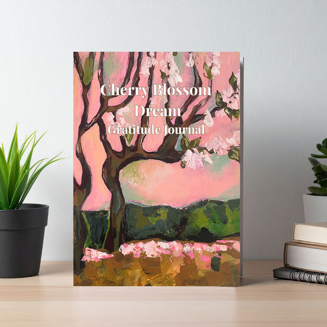 Cherry Blossom Dream gratitude journal with floral artwork cover displayed on a table, aesthetic mindfulness journal for daily reflection