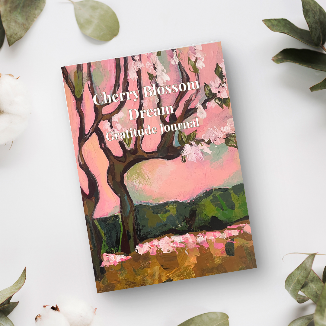 Cherry Blossom Dream gratitude journal with floral artwork in a soft flat lay setting, aesthetic mindfulness journal for daily reflection
