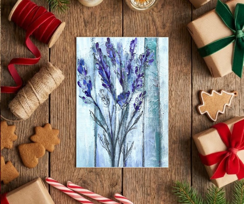 Ethereal lavender greeting card with soft abstract floral artwork displayed on a wooden table with gift boxes and festive decorations