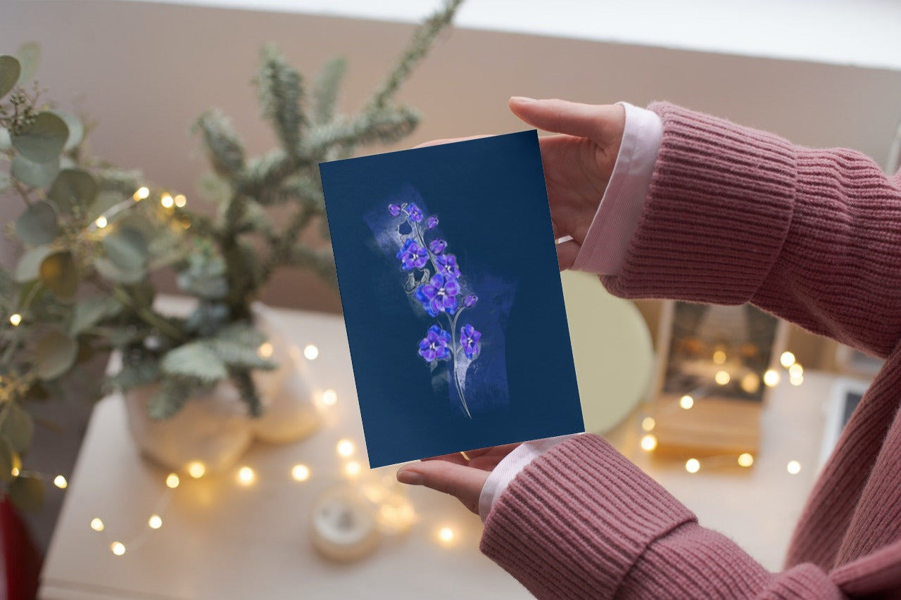 Hand holding July Larkspur birth flower greeting card