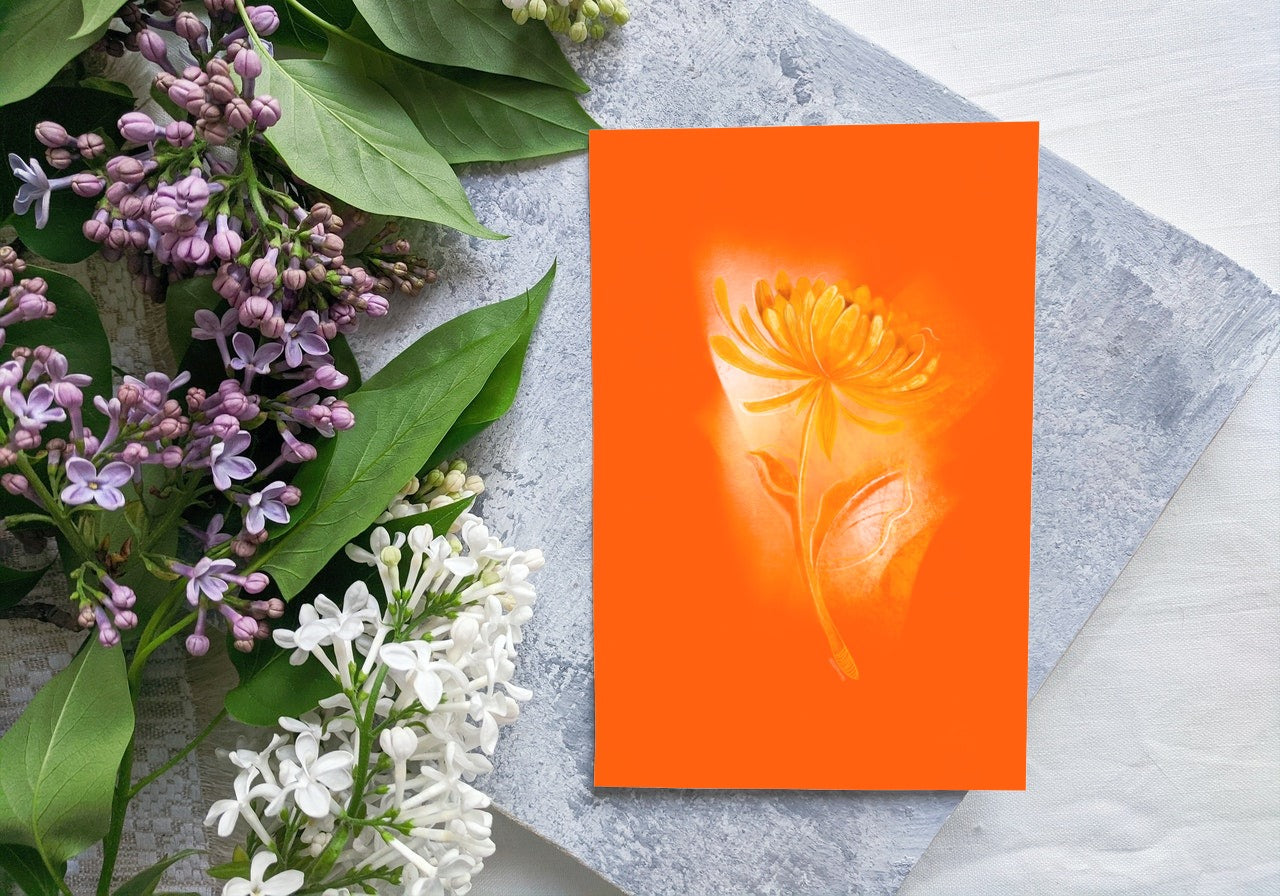 November Chrysanthemum birth flower greeting card placed beside fresh flowers for a natural, artistic look.