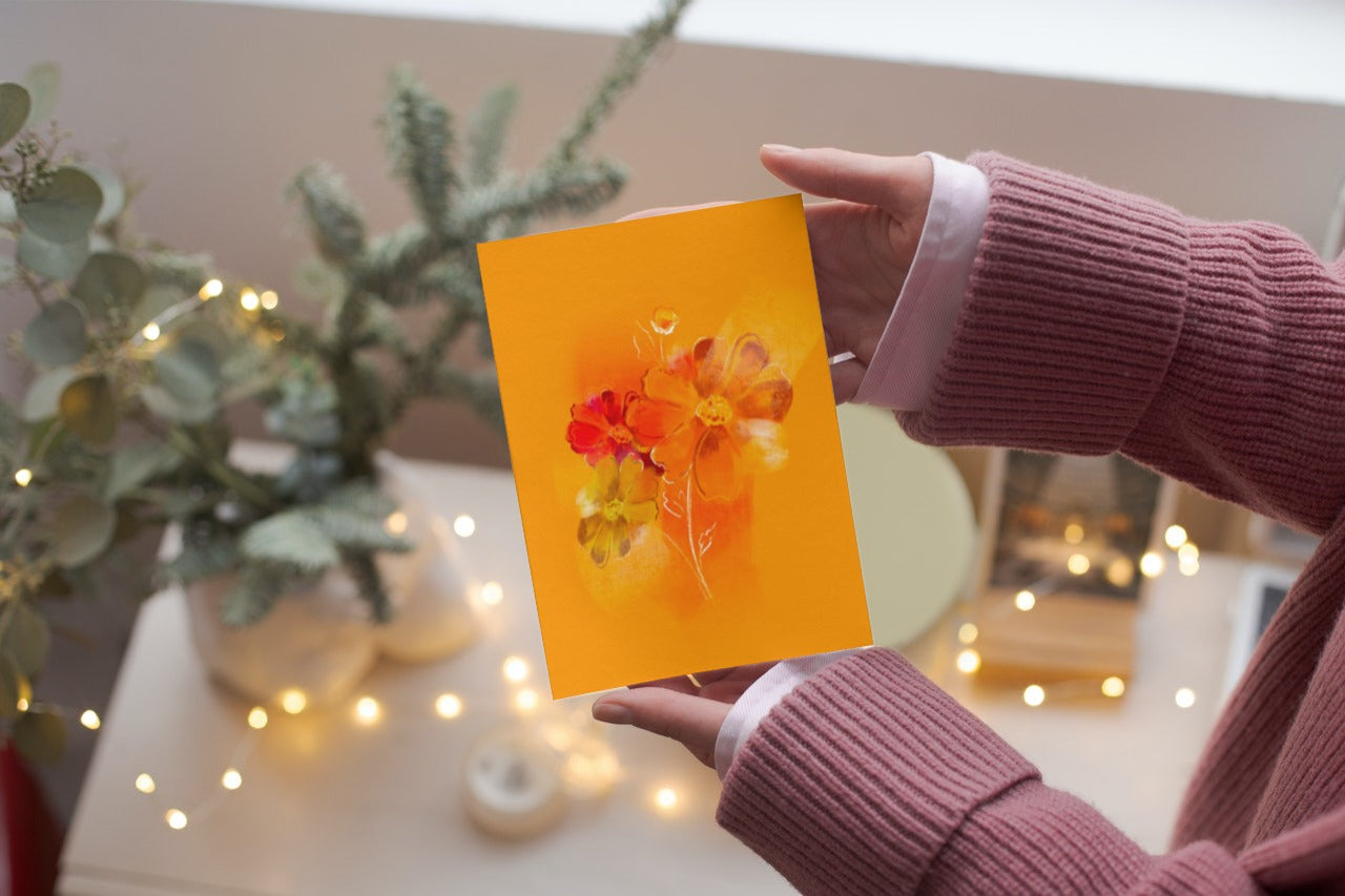 Person holding October birth flower cosmos greeting card