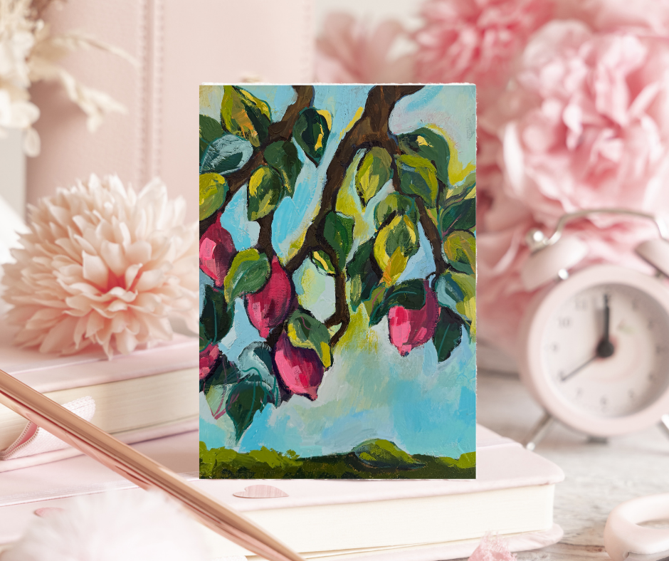 Purple lemons greeting card with vibrant botanical artwork displayed on a soft pink desk with flowers, books, and a clock