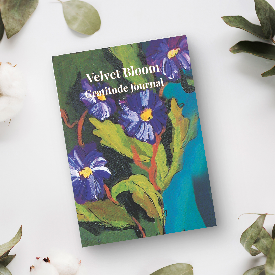 Velvet Bloom gratitude journal with floral artwork in flat lay styling, ideal for mindfulness, journaling, and thoughtful gifts
