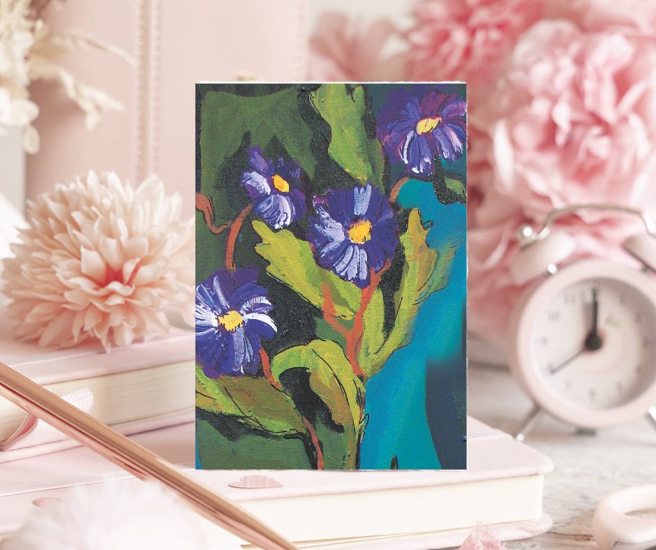Velvet Bloom greeting card displayed on a desk with books, flowers, and a clock, featuring abstract floral artwork