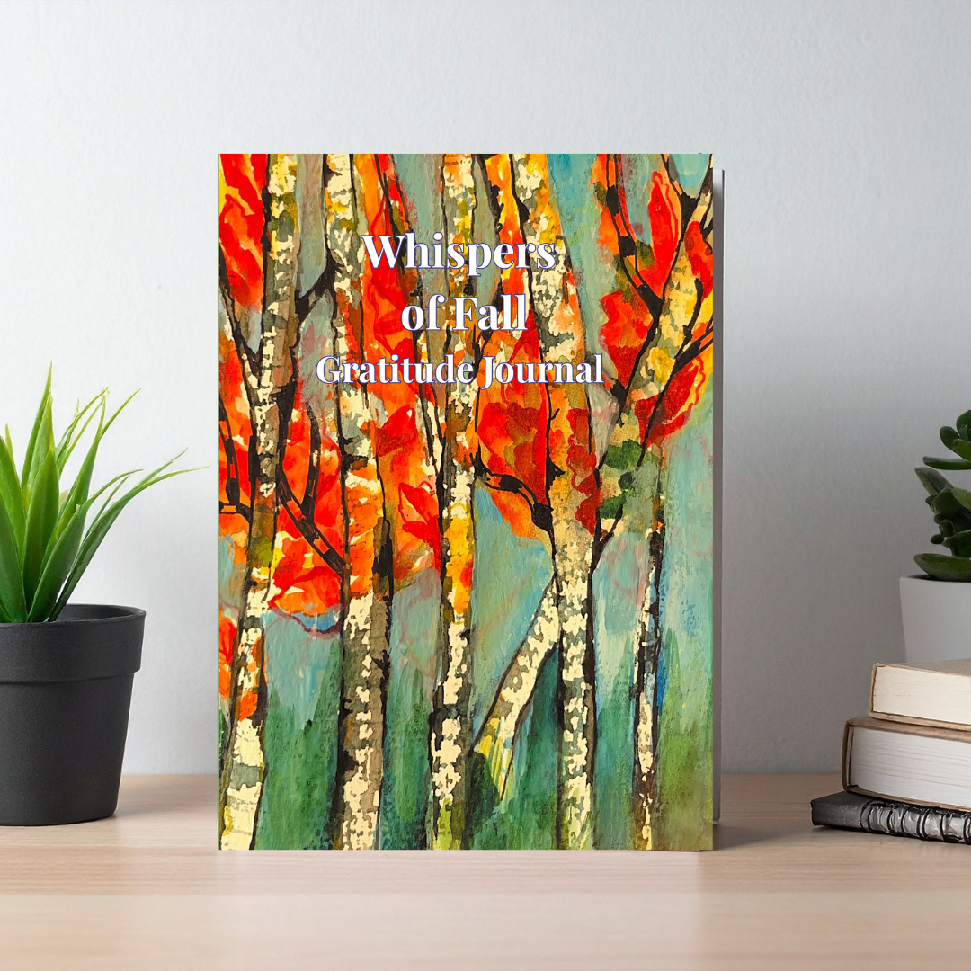 Whispers of Fall gratitude journal with autumn-inspired artwork displayed on a desk in a calm lifestyle setting