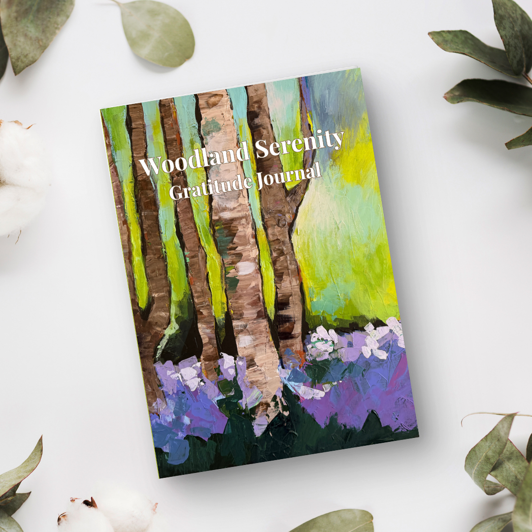 Woodland Serenity gratitude journal with forest-inspired artwork placed on a white background with natural elements in a calm, styled flat lay