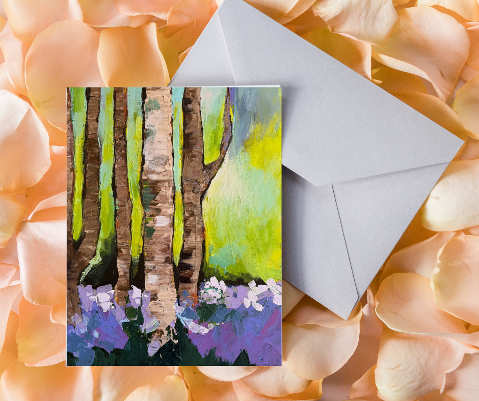 Woodland Serenity greeting card with impressionist forest artwork displayed with an envelope on a floral background