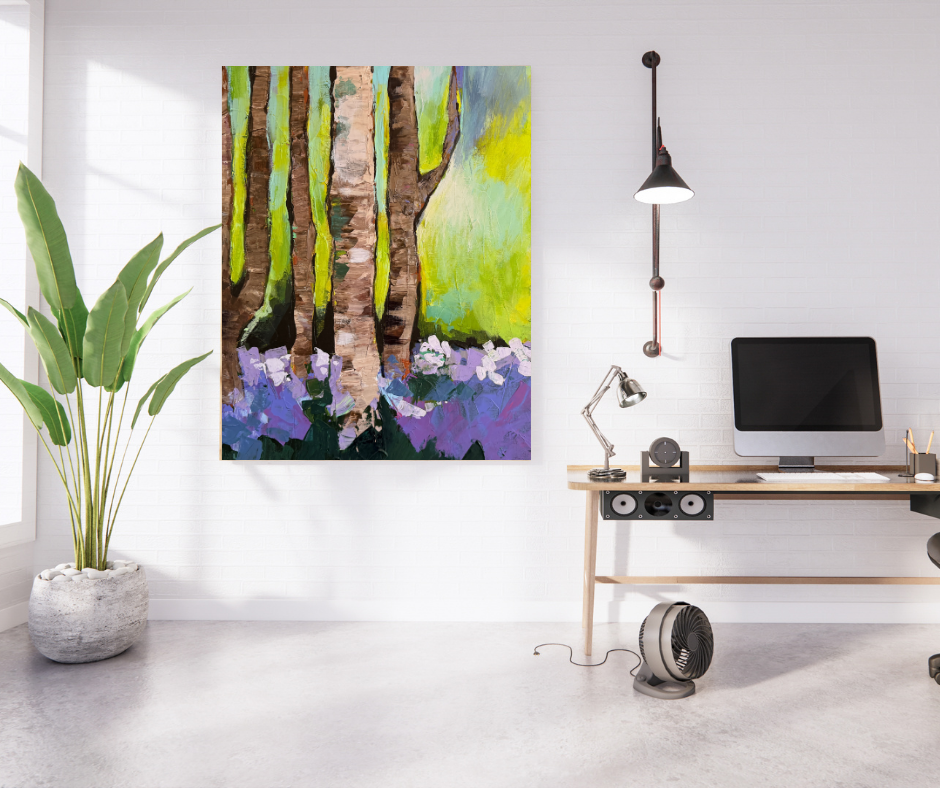 Green and purple forest canvas wall art displayed above a desk in a bright modern home office